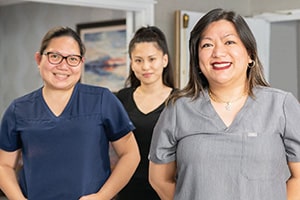 Three caregivers standing in the hallway at Victorian post acute
